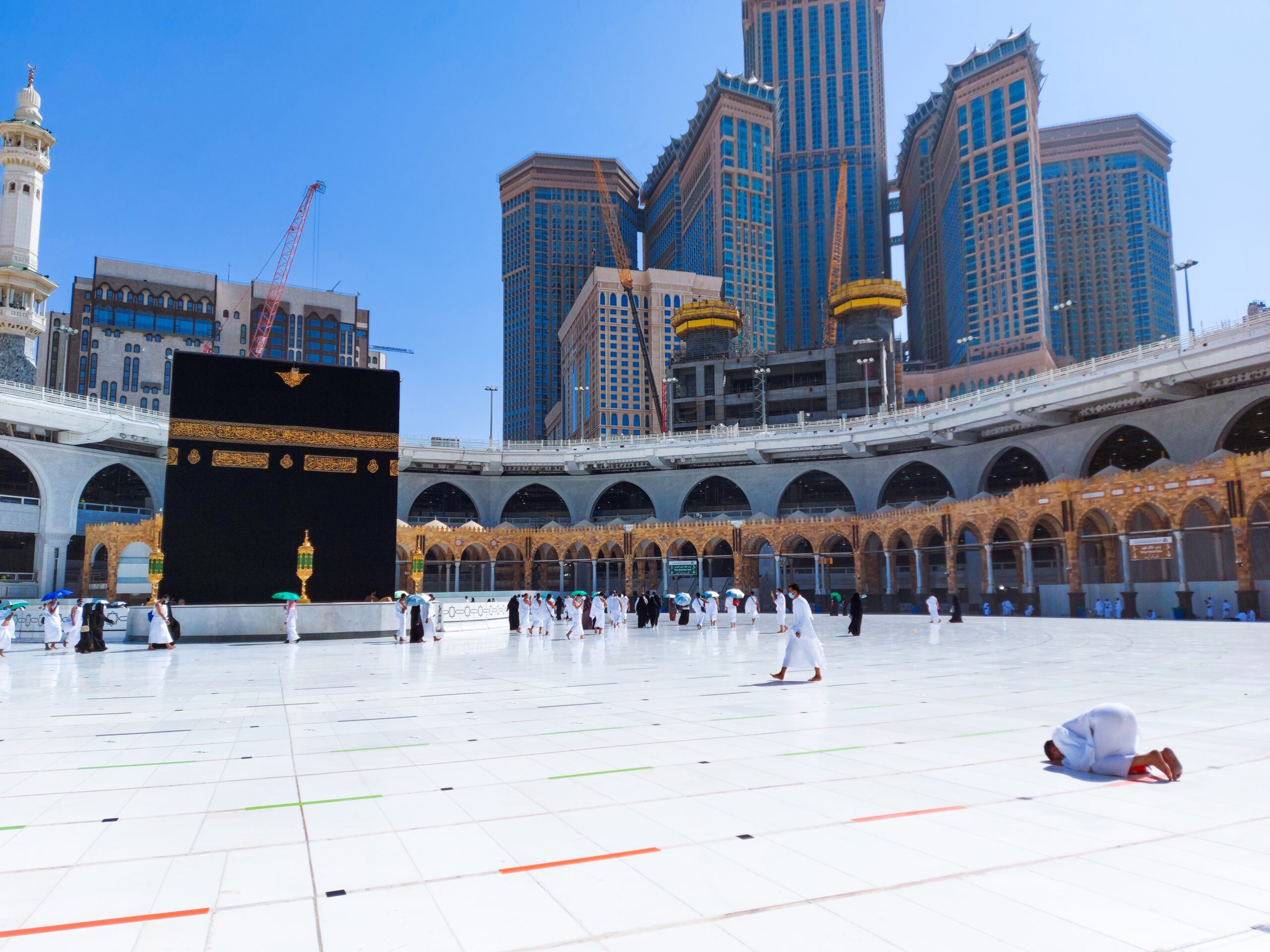 MECCA , SAUDI ARABIA , OCT/22/2020 - Pilgrims circle the Kaaba at Masjid al-Haram - umrah Fewer Muslims people Socially Distanced corona virus wearing face mask Covid 19