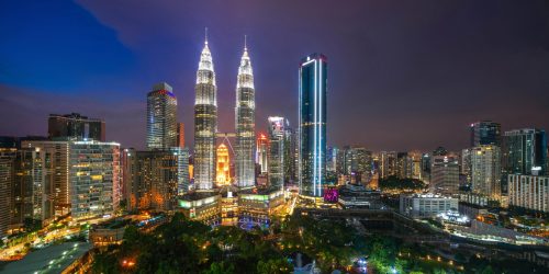 Aerial view of Kuala Lumpur Downtown, Malaysia. Financial district and business centers in smart urban city in Asia. Skyscraper and high-rise buildings at night.