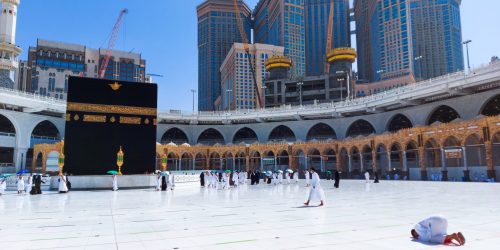 MECCA , SAUDI ARABIA , OCT/22/2020 - Pilgrims circle the Kaaba at Masjid al-Haram - umrah Fewer Muslims people Socially Distanced corona virus wearing face mask Covid 19